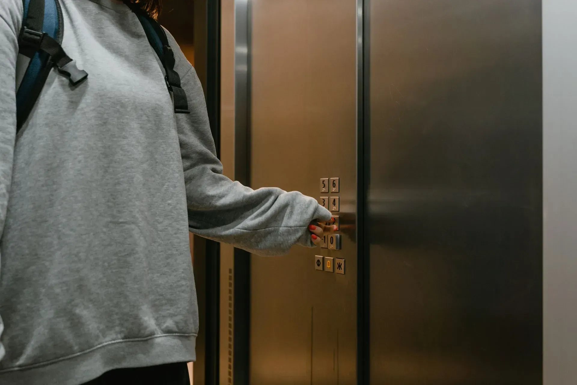 student-pressing-elevator-button