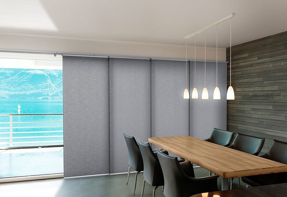 A Dining Room With a Large Table and Chairs — Tully Blinds in Tully, QLD