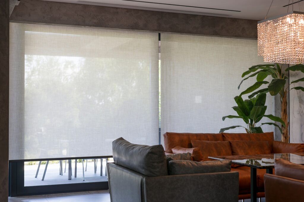 A Living Room With a Couch and a Chandelier — Tully Blinds in Tully, QLD