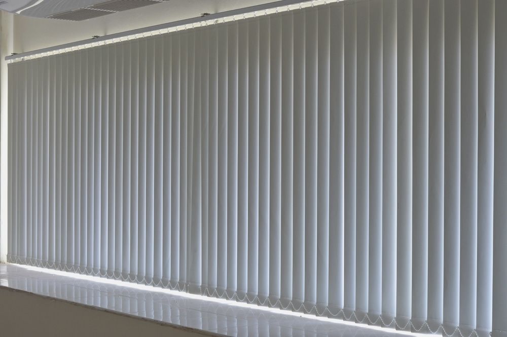 A Room With a Lot of Vertical Blinds on the Windows — Tully Blinds in Tully, QLD