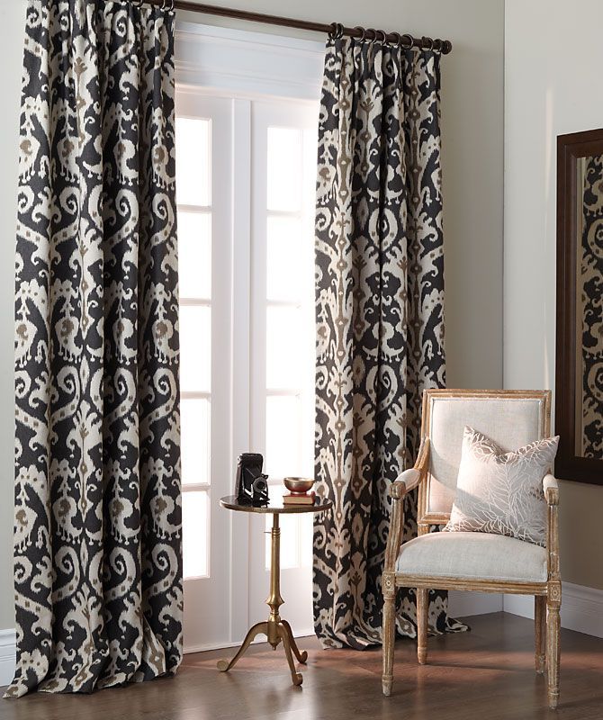A living room with black and white curtains and a chair