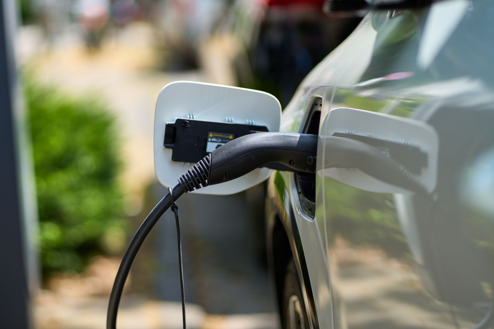 An electric car is being charged at a charging station.