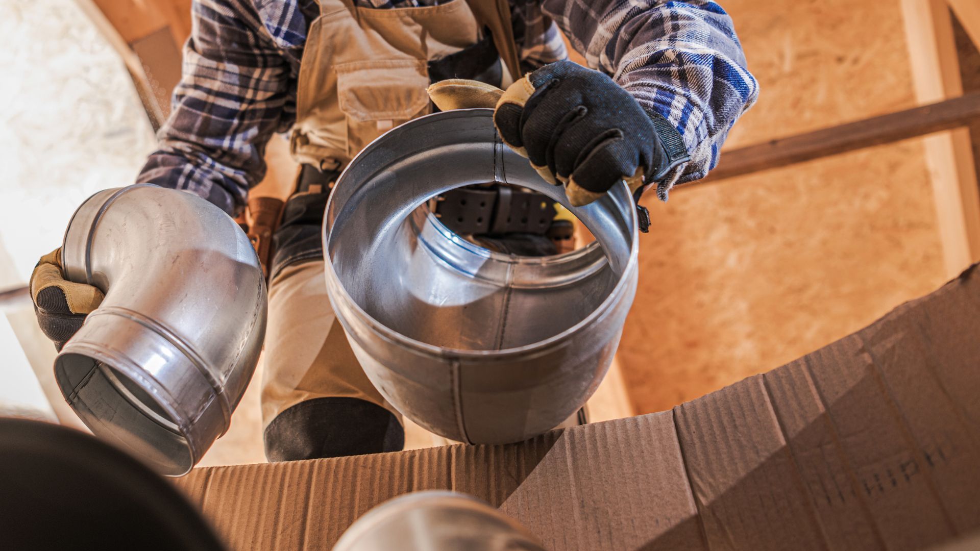 A man is holding a metal pipe in his hands.