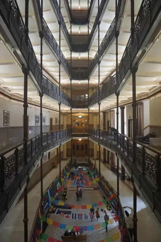 A large building with a lot of windows and a colorful floor.