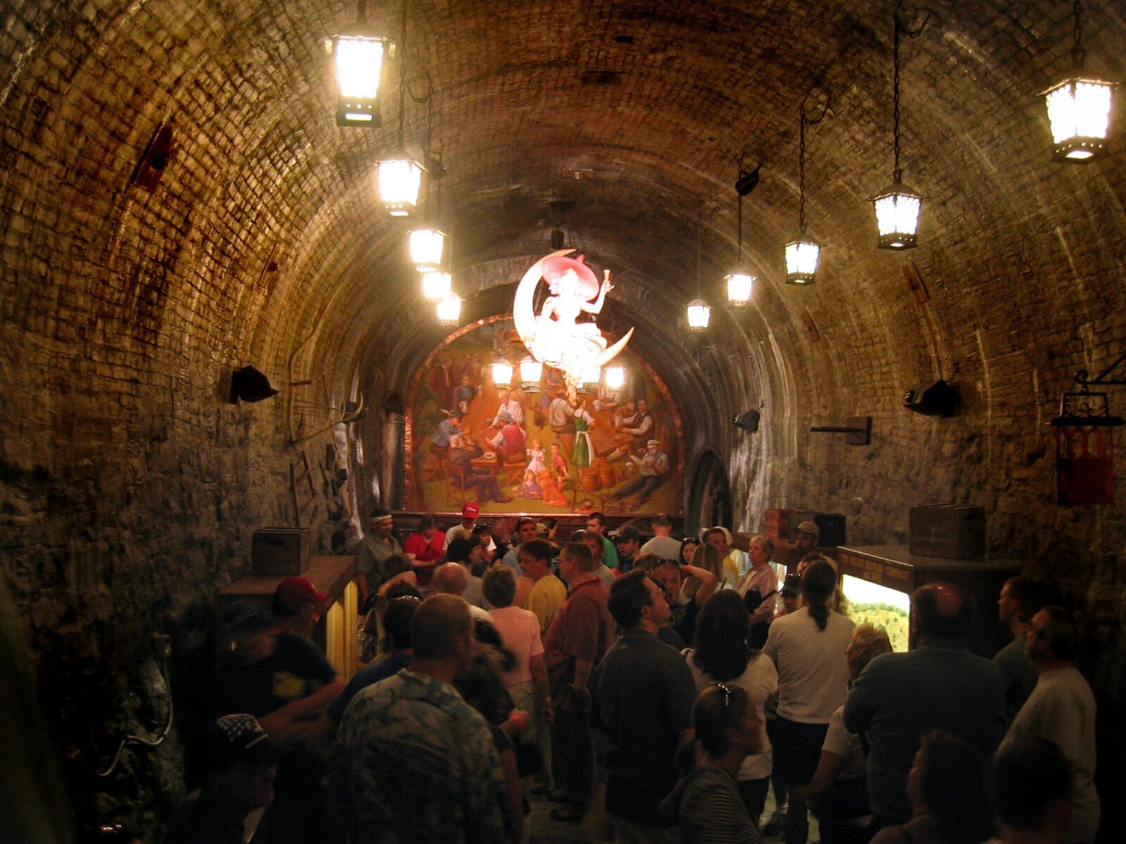 A large group of people are standing in a dark tunnel.