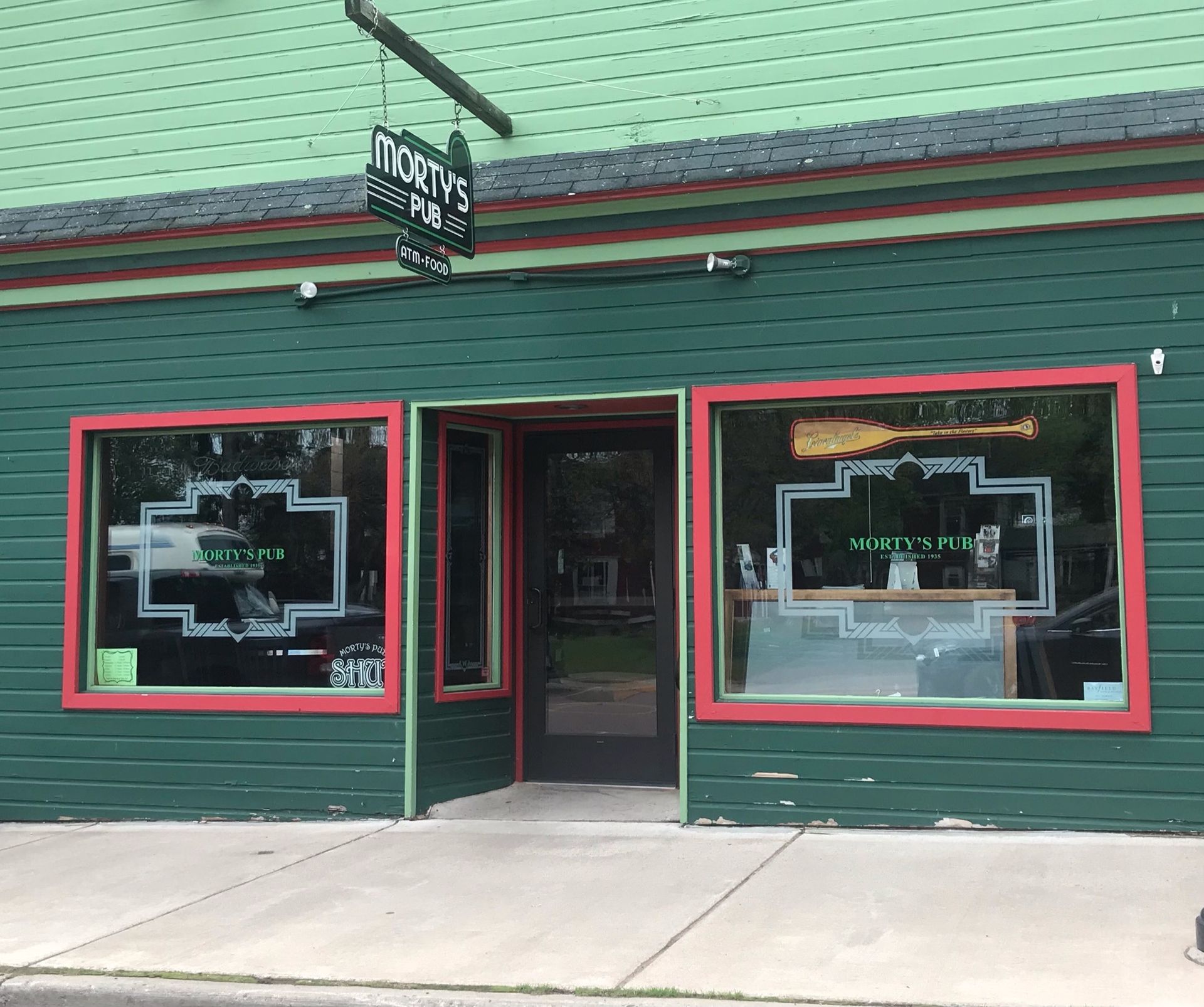 A green building with a sign that says ' charles ' on it