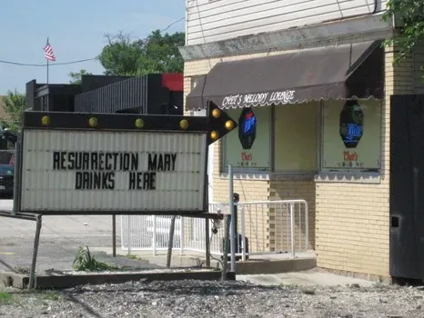 A building with a sign that says resurrection mary drinks here