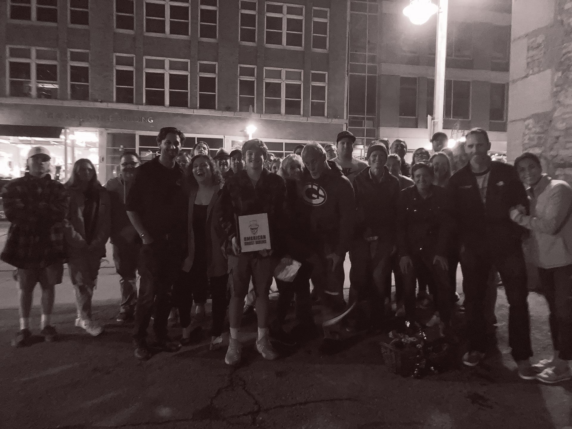 A group of people standing in front of a building with a sign that says police
