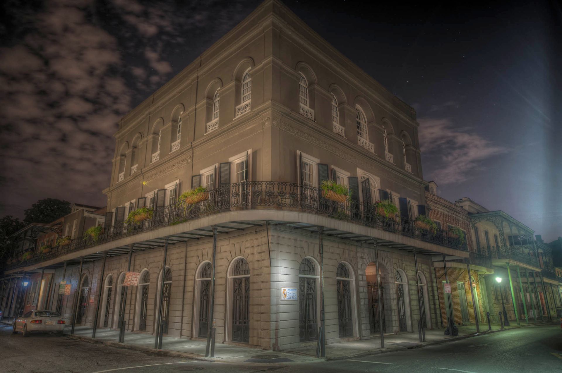 A large building with a balcony on the corner of it