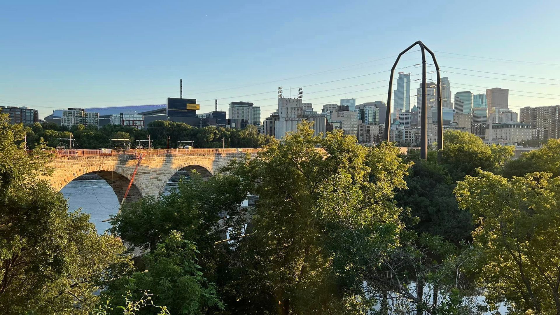 A bridge over a river with a city in the background