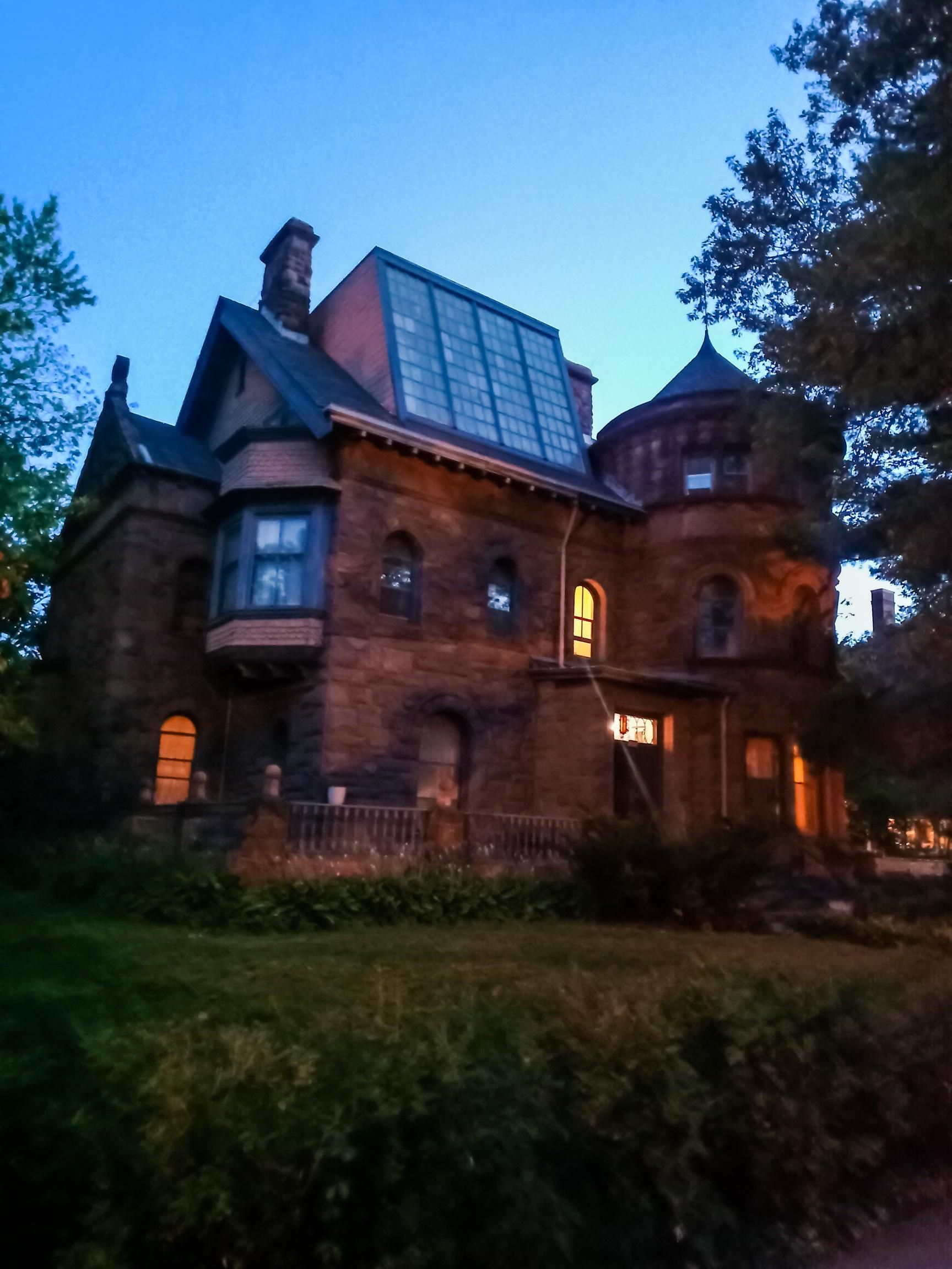 A large brick house with a solar panel on the roof