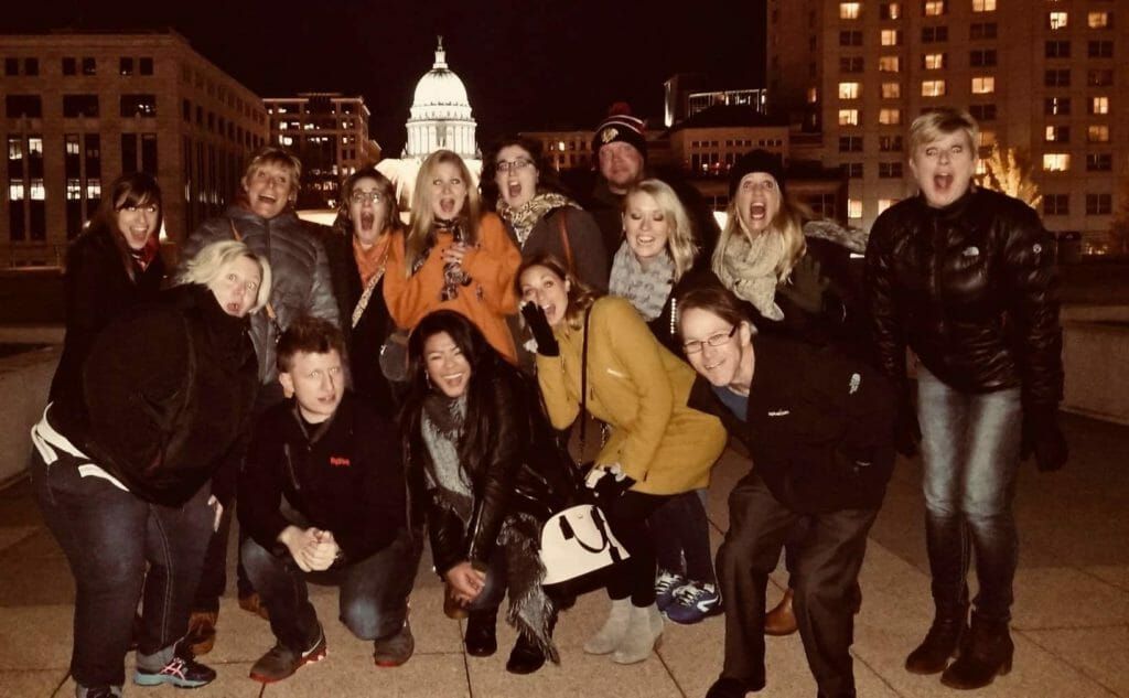 A group of people posing for a picture in front of a building