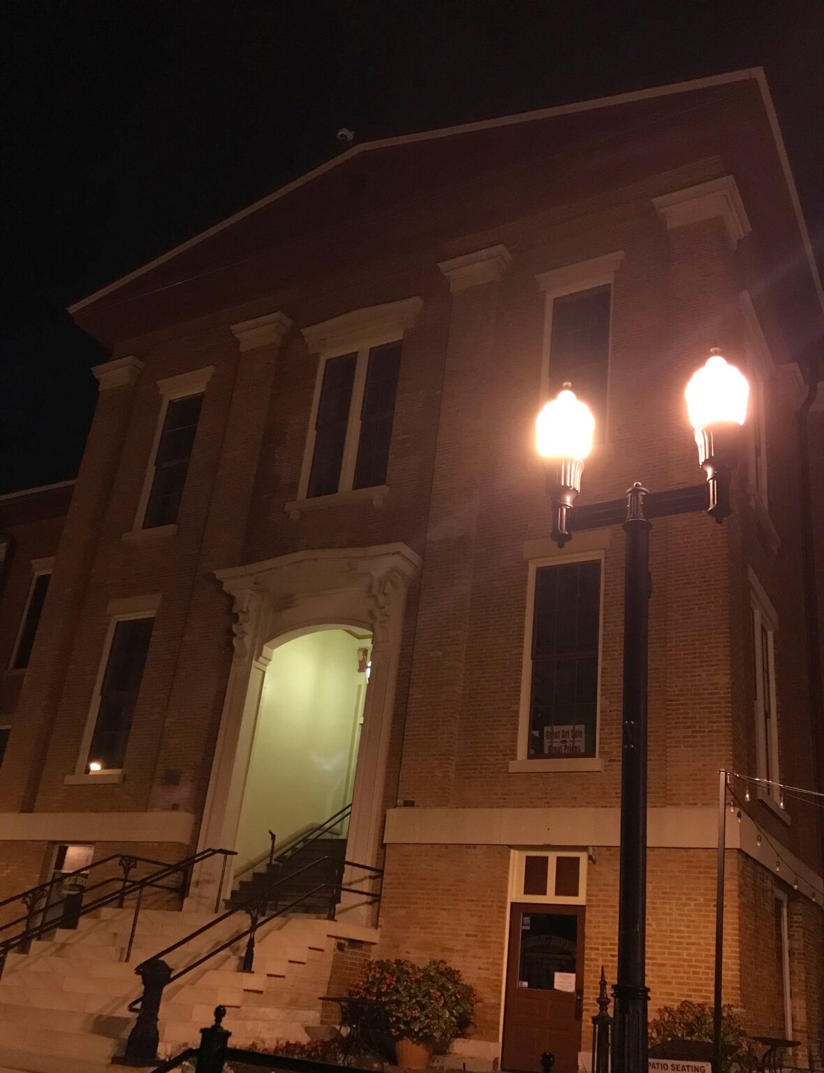 A large brick building is lit up at night