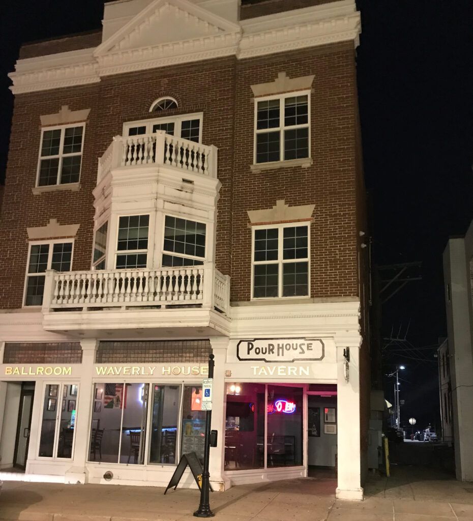 A brick building with a sign that says pour house tavern