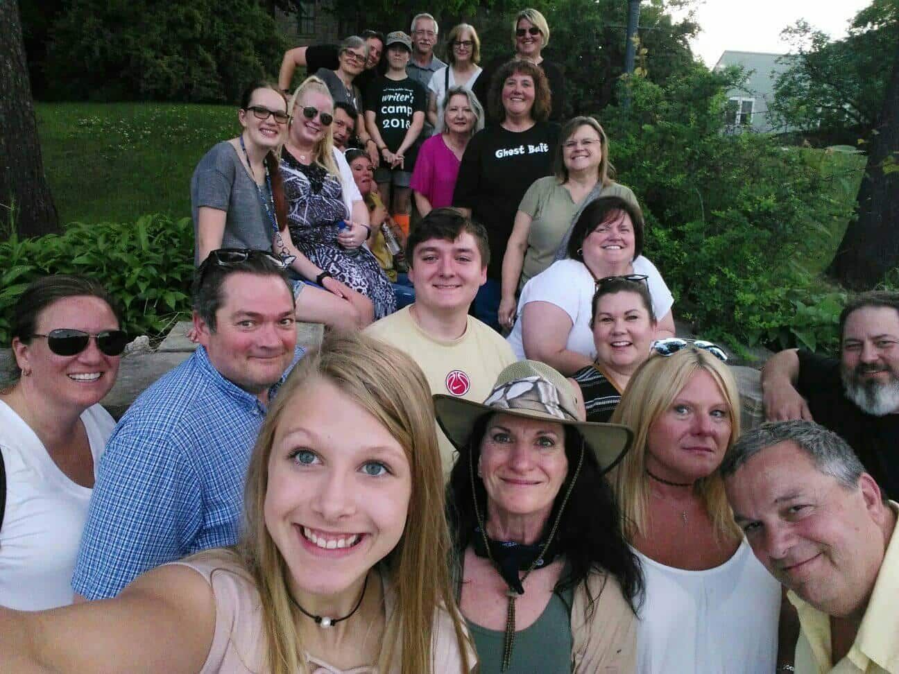 A group of people posing for a picture with one woman wearing a cowboy hat