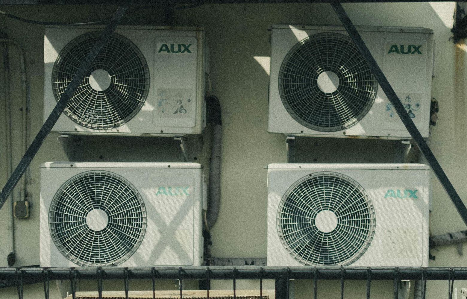 Four aux air conditioners are stacked on top of each other