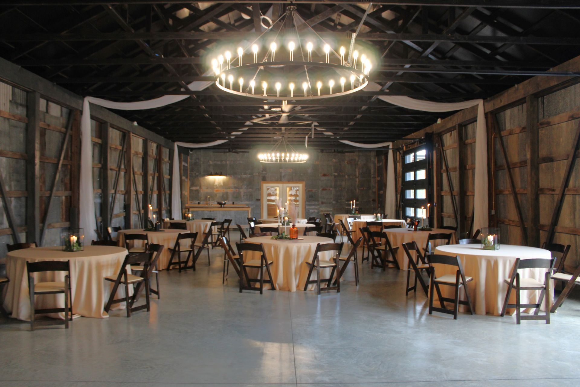The polished concrete floor gleams with a contemporary finish, providing a sleek and versatile surface for events.