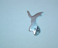 Silver-colored gun hammer, with a curved spur and two holes at its base, on a light blue background.