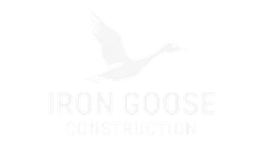 Iron Goose Construction logo with a faint flying goose silhouette on a white background