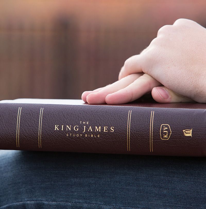 A holy bible is sitting on a stand in a church.