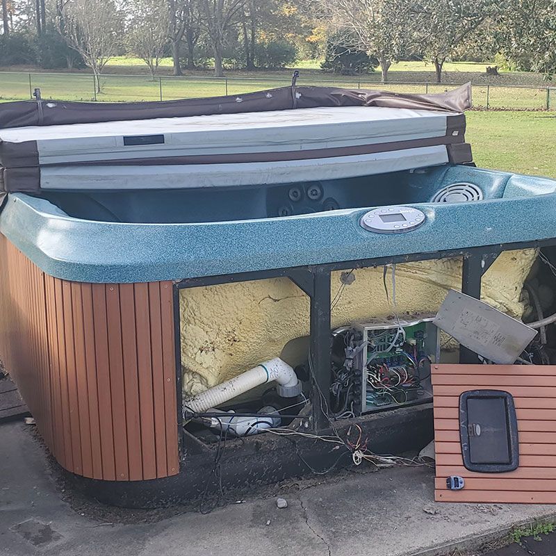 broken hot tub on concrete patio, hot tub removal