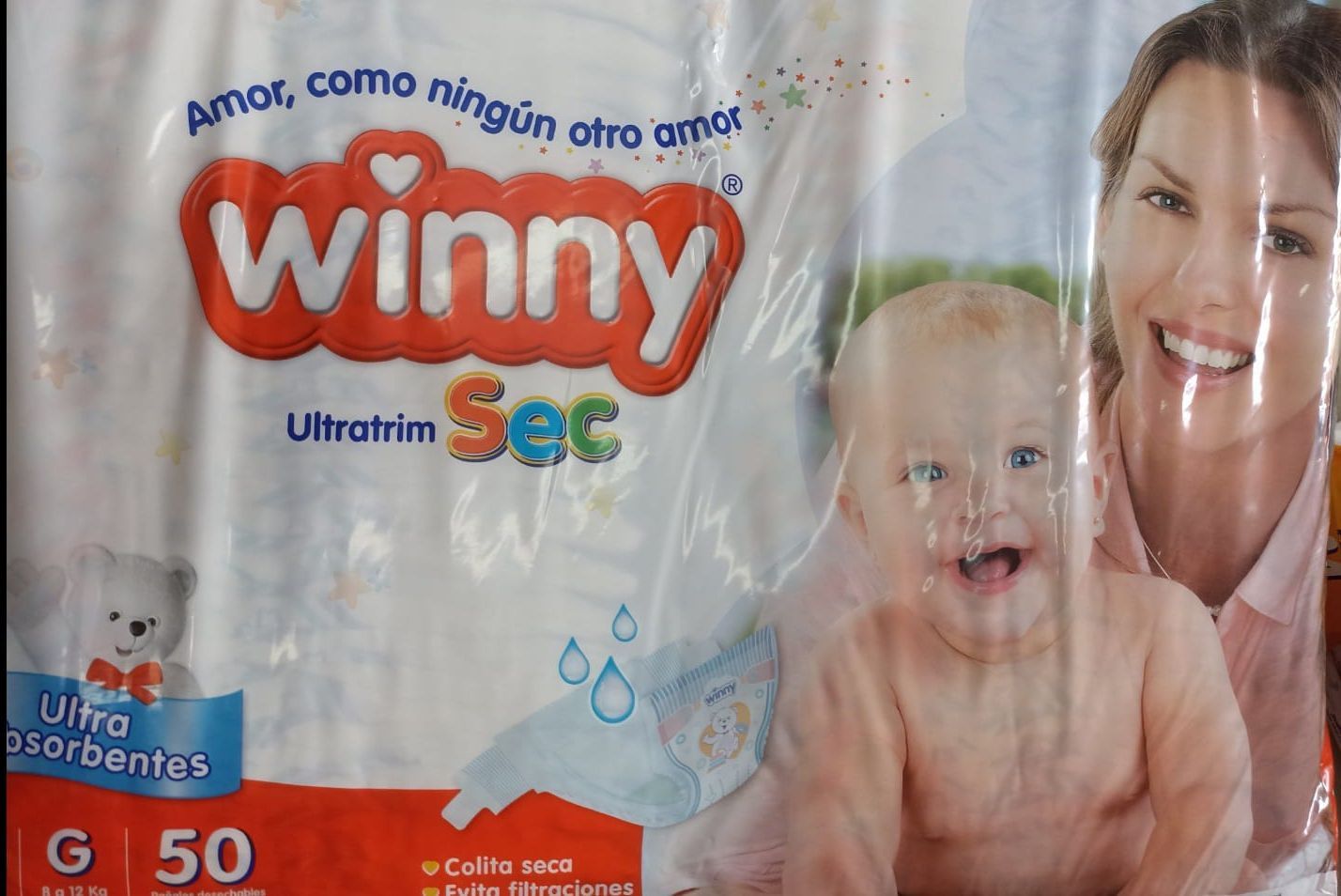 Paquete de pañales Winny Sec para bebé con diseño de bebé y madre sonrientes, blanco y naranja, 50 unidades.