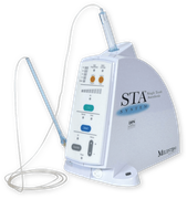 A white STA System dental anesthesia device with a handpiece and a syringe.
