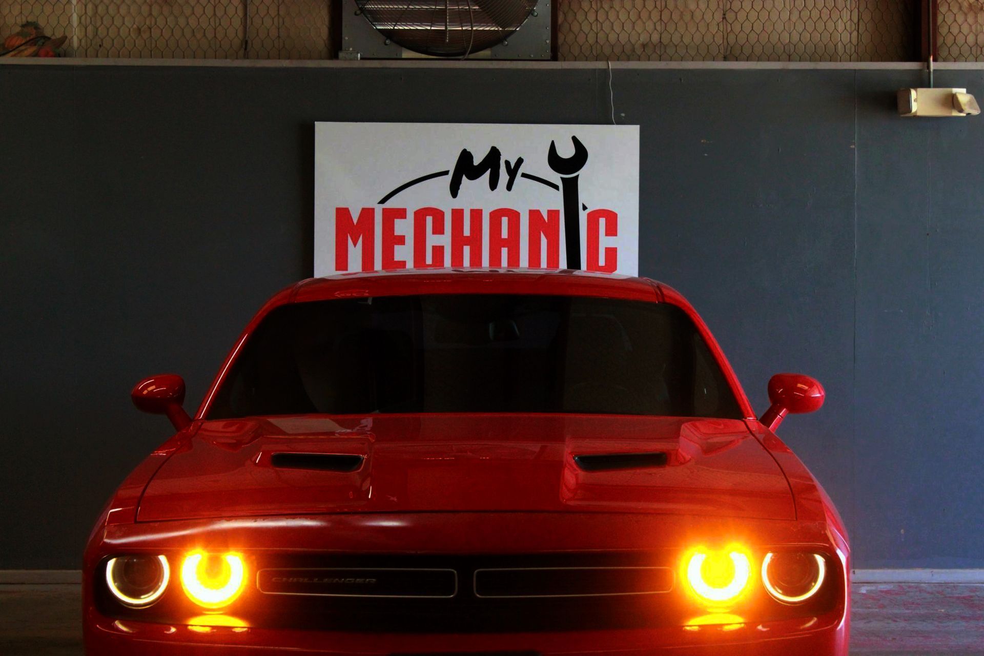 Red Dodge Challenger in front of 