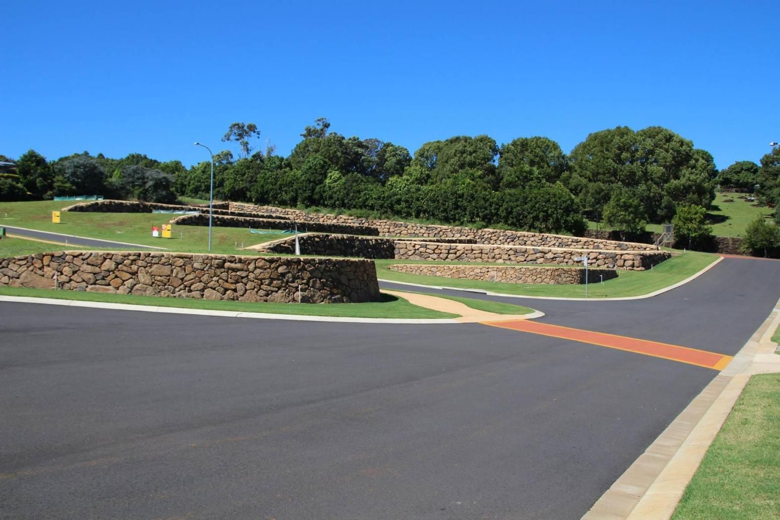 A Road With A Stone Wall On The Side Of It — Australian Rock Walls In Beechmont, QLD