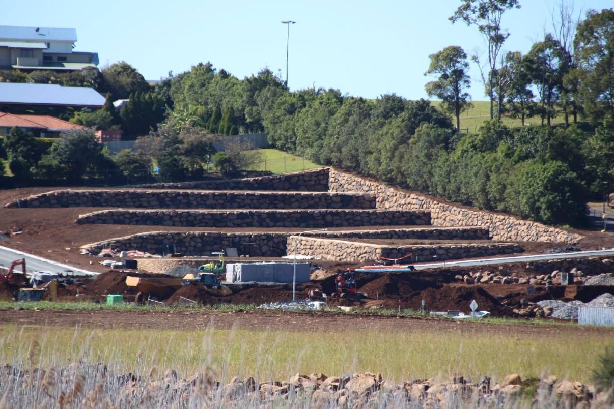 A Large Pile Of Dirt Is Sitting In The Middle Of A Field — Australian Rock Walls In Brisbane, QLD