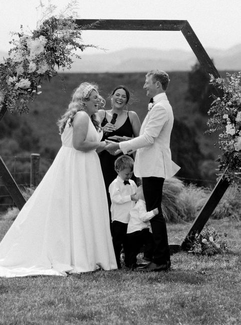 Nelson celebrant Britt laughing mid-ceremony as bride and groom hold hands