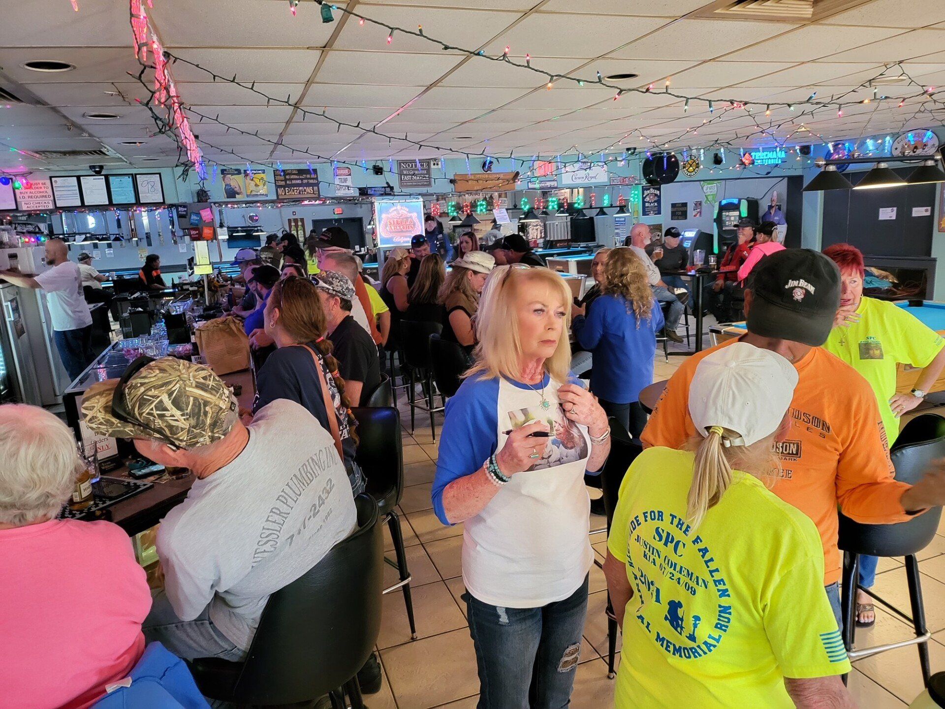 A Group Of People Standing And Talking At The Bar | Foley, AL | The Office Lounge