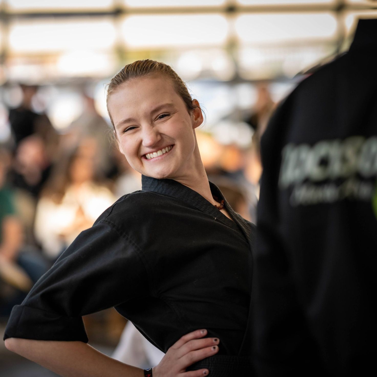 teen posing in their martial arts class