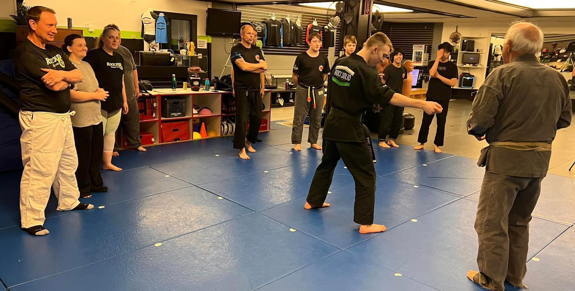 students practicing self-defense techniques in a focused class setting