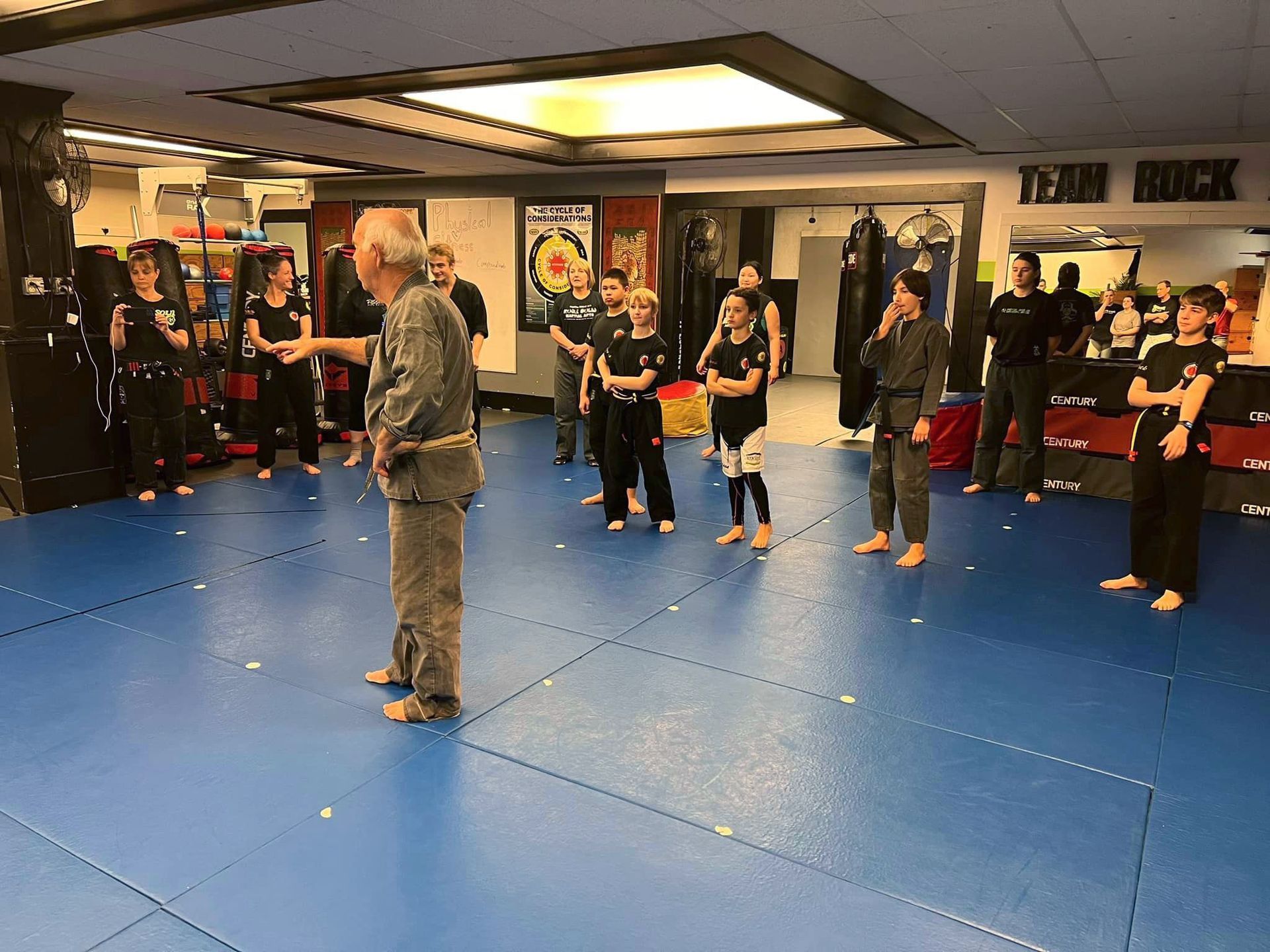 group of students attentively listening to self-defense instructions