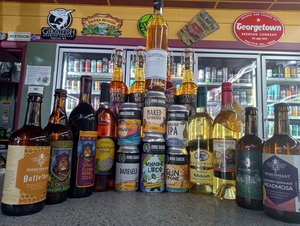 A variety of beer bottles and cans in front of a georgetown sign