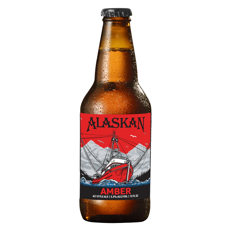 Alaskan Amber beer bottle. Red and black label with a boat on a mountain scene.