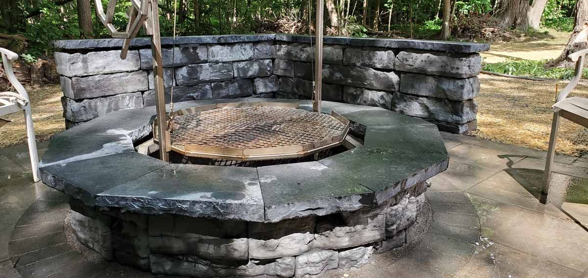 Stone well with a circular cover in an outdoor garden setting