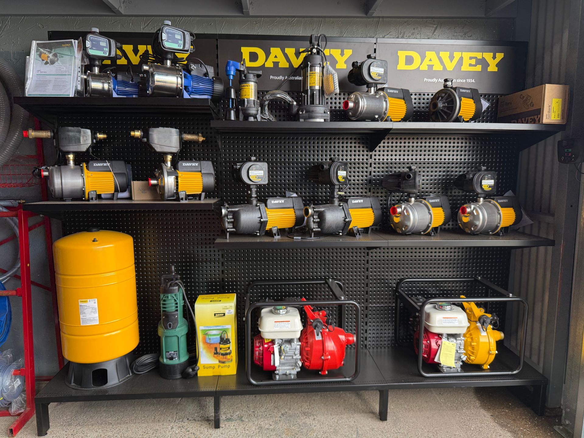 Shelf of Davey power tools and equipment displayed in a store, with yellow and black branding. — Taree Water Works in Taree, NSW