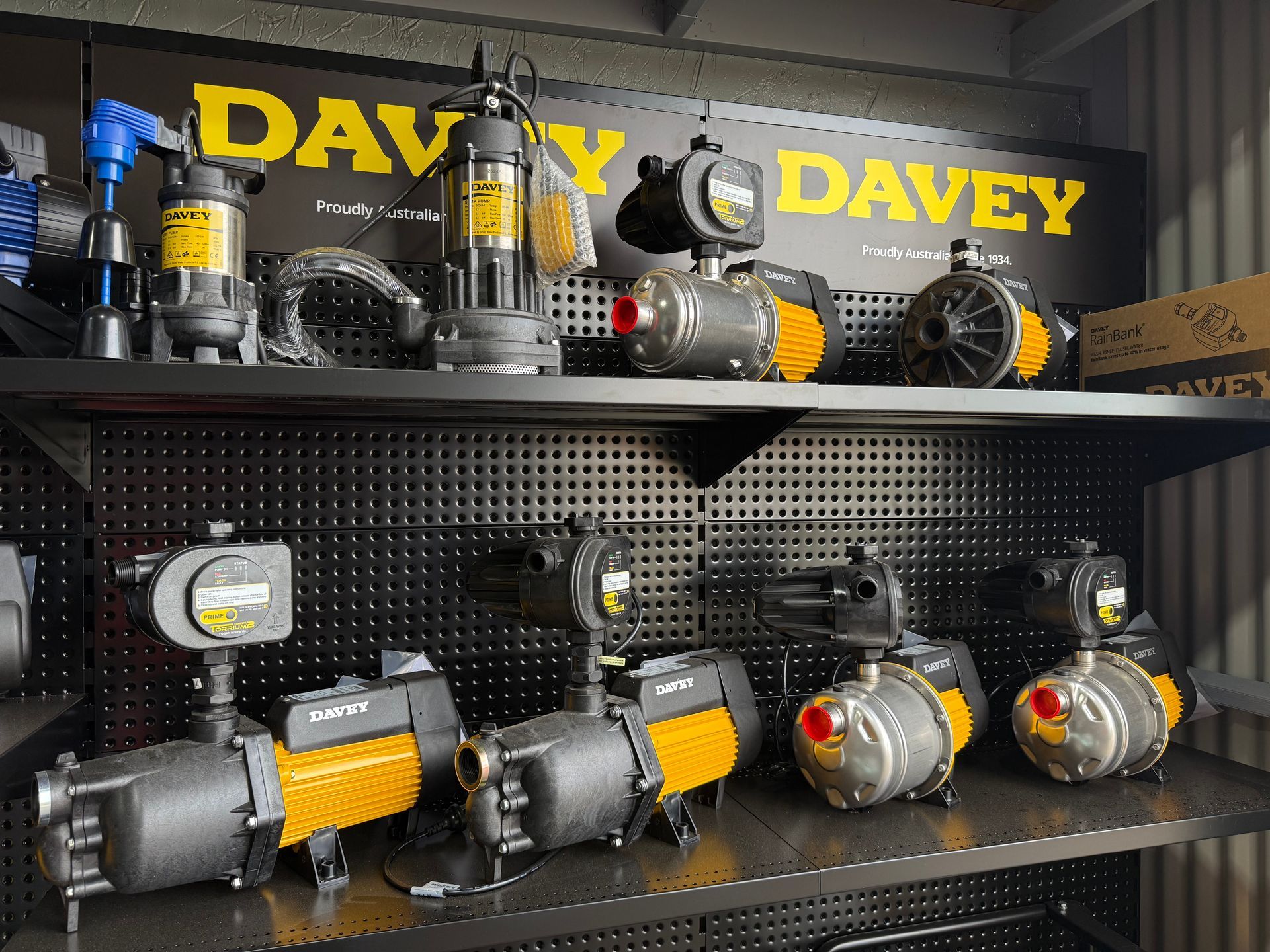 Shelving with yellow-and-gray Davey pumps and motors displayed in a store — Taree Water Works in Taree, NSW