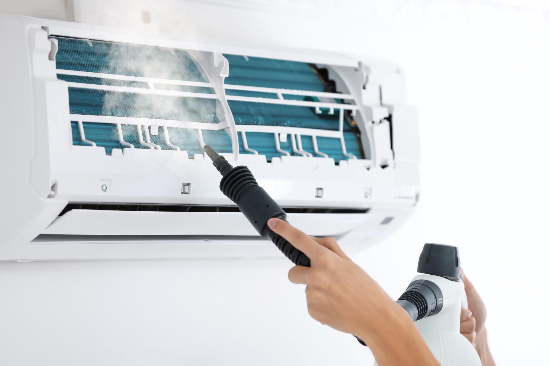 Cleaning spray inside wall-mounted air conditioner with a brush and spray bottle