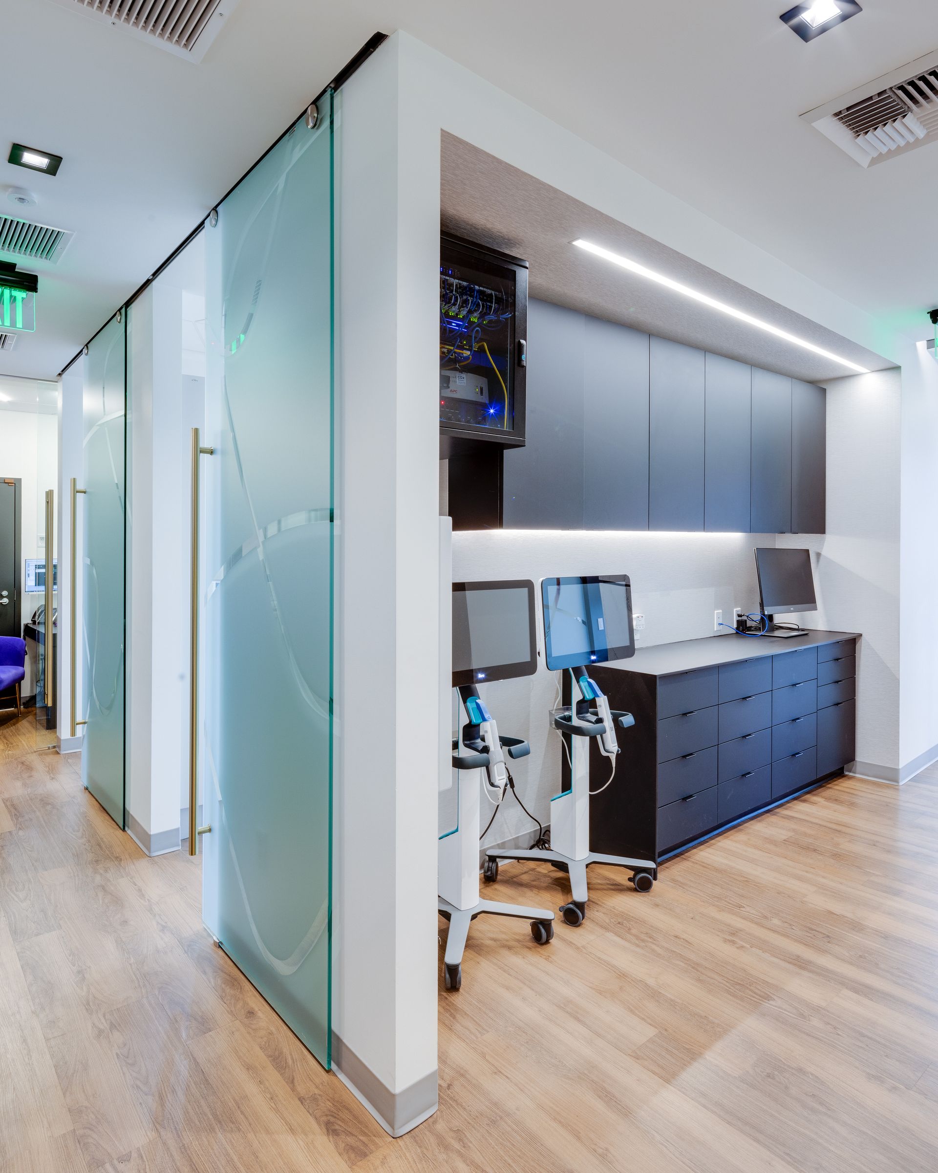 A dental office with sliding glass doors and a purple chair