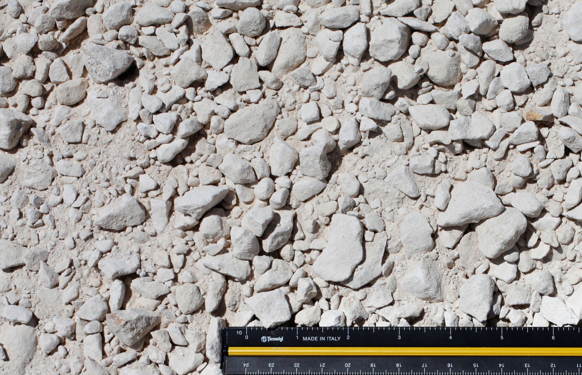 A ruler is laying on top of a pile of rocks