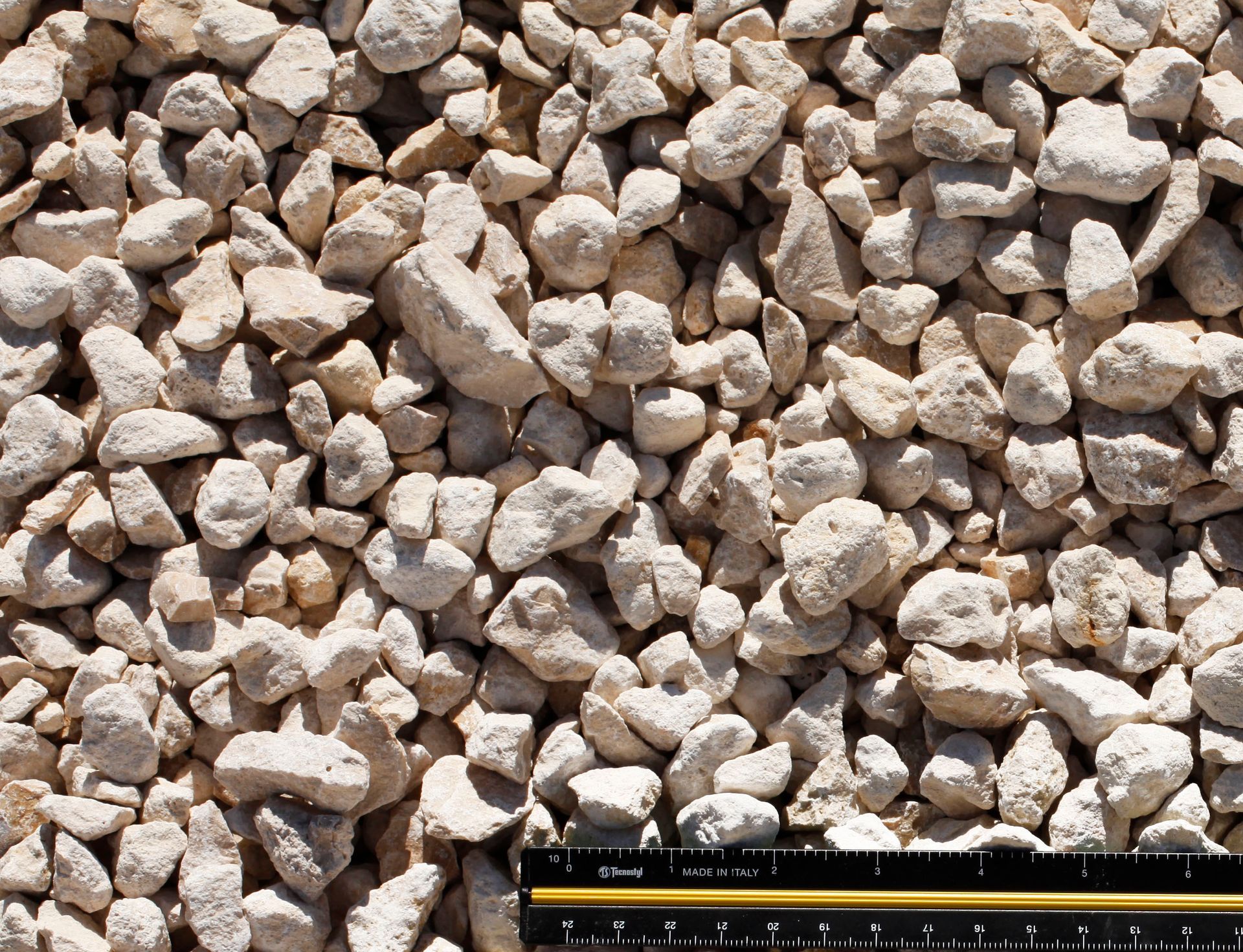 A ruler is sitting on top of a pile of rocks.