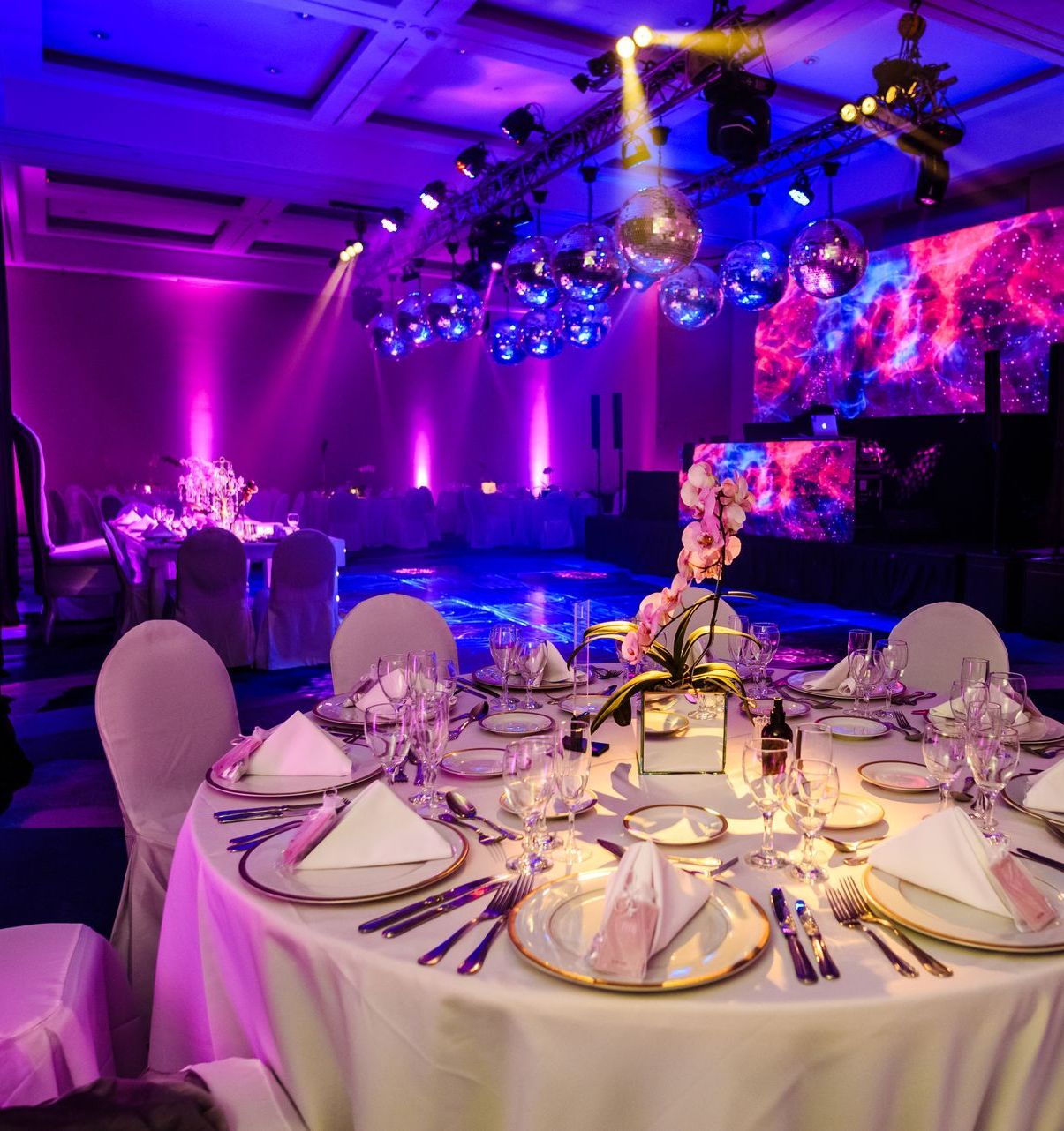 Una gran sala con mesas y sillas preparadas para una fiesta.
