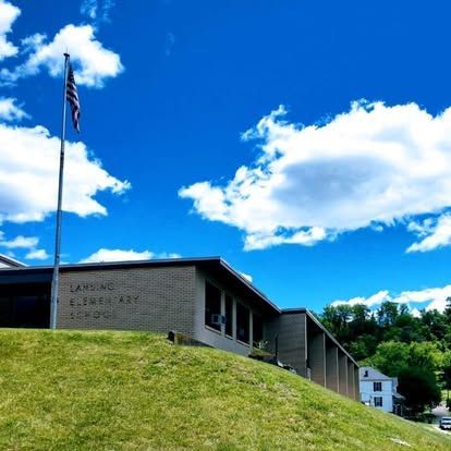 Lansino elementary school with a flag in front of it