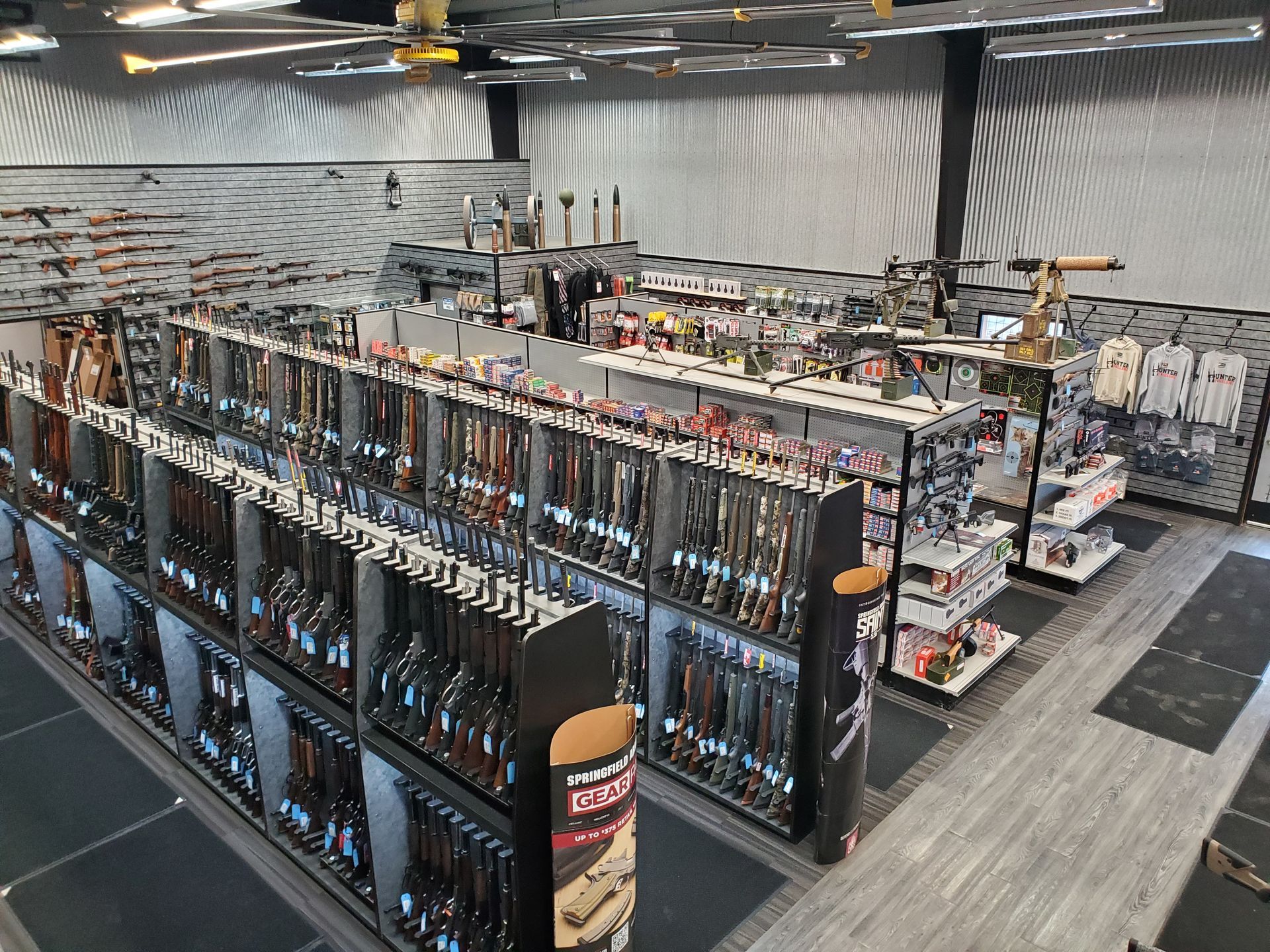 Interior of a gun store with displays of firearms, ammunition, and accessories.