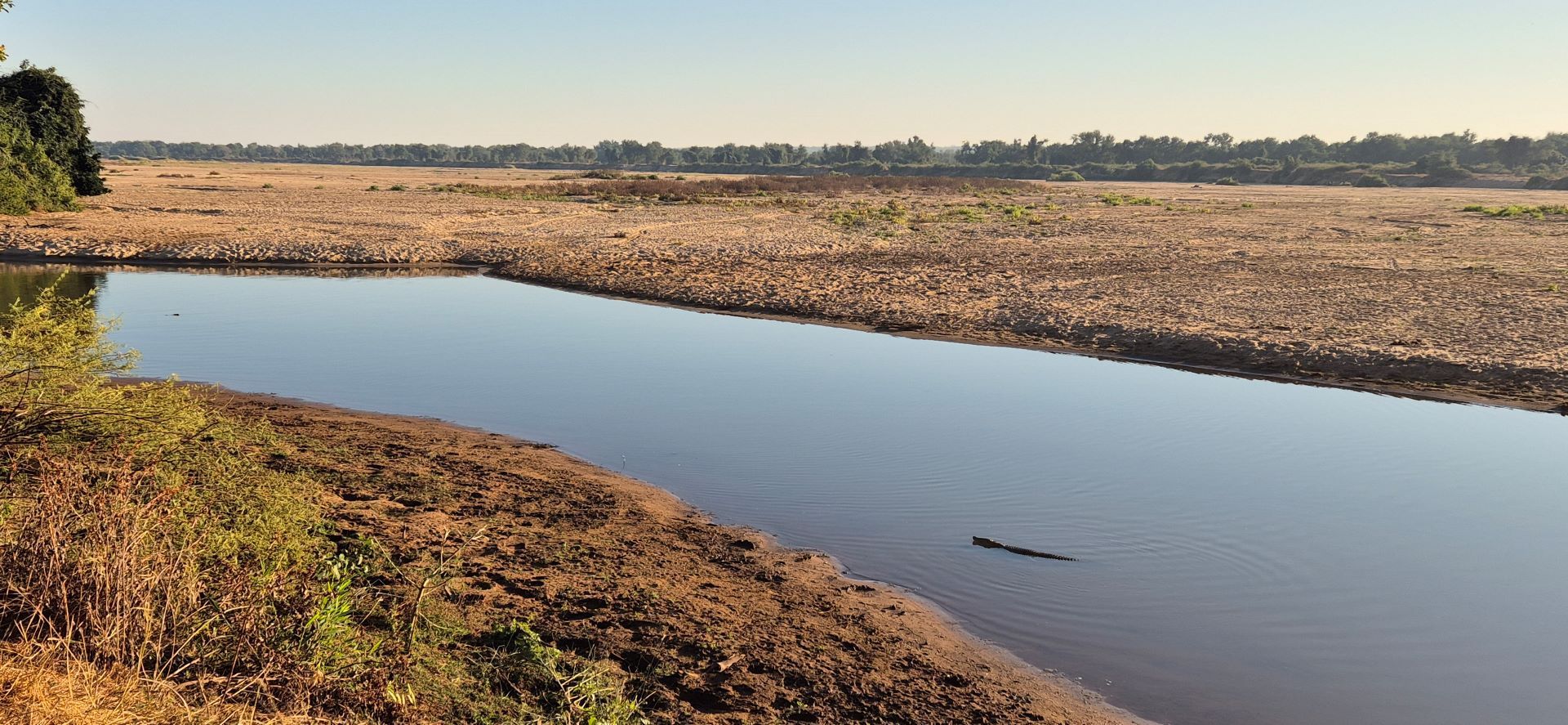Calm river in the kruger national park with stones safaris