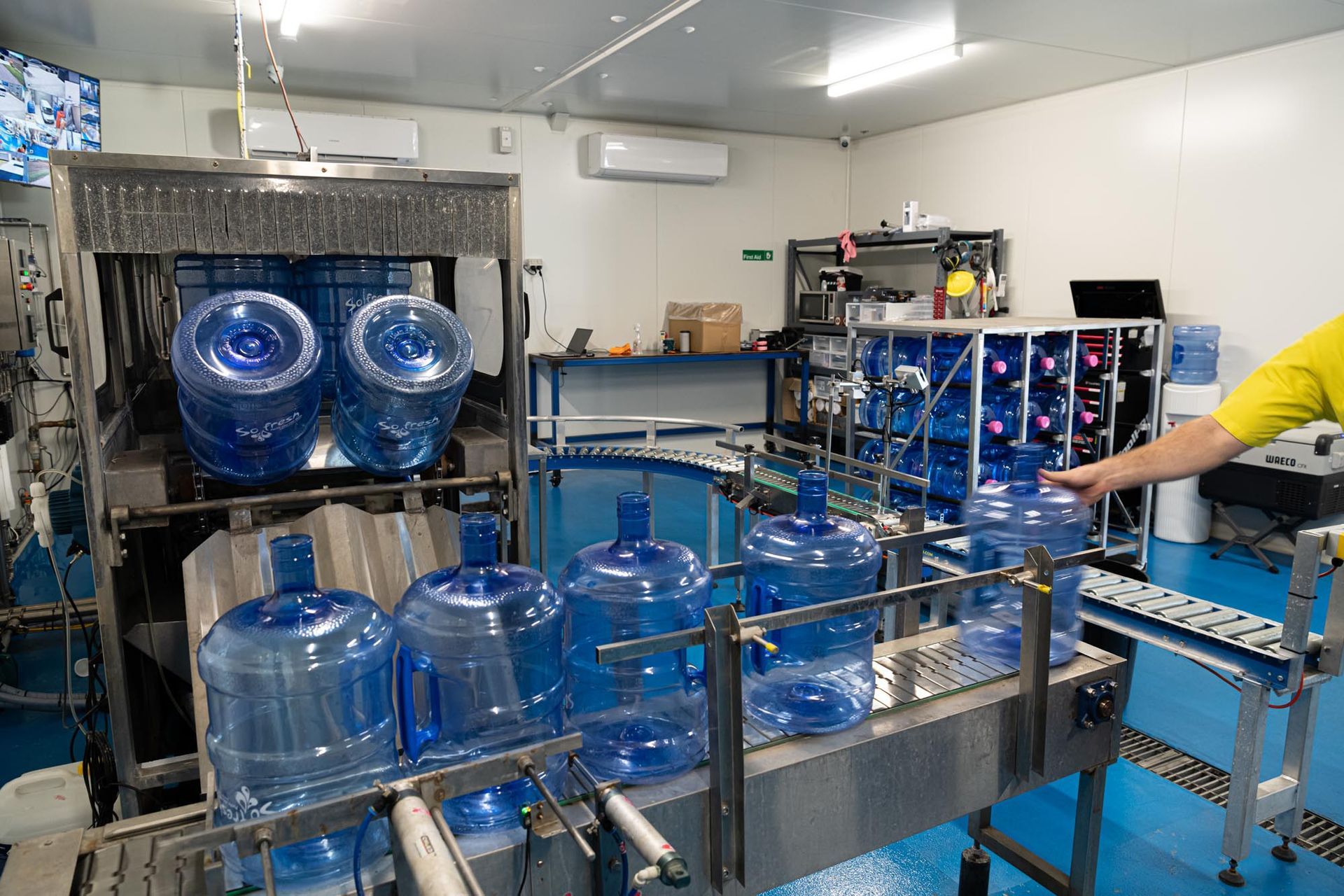 Industrial Bottling LINE With Blue Water Jugs and a Worker — So Fresh Wide Bay in Thabeban, QLD