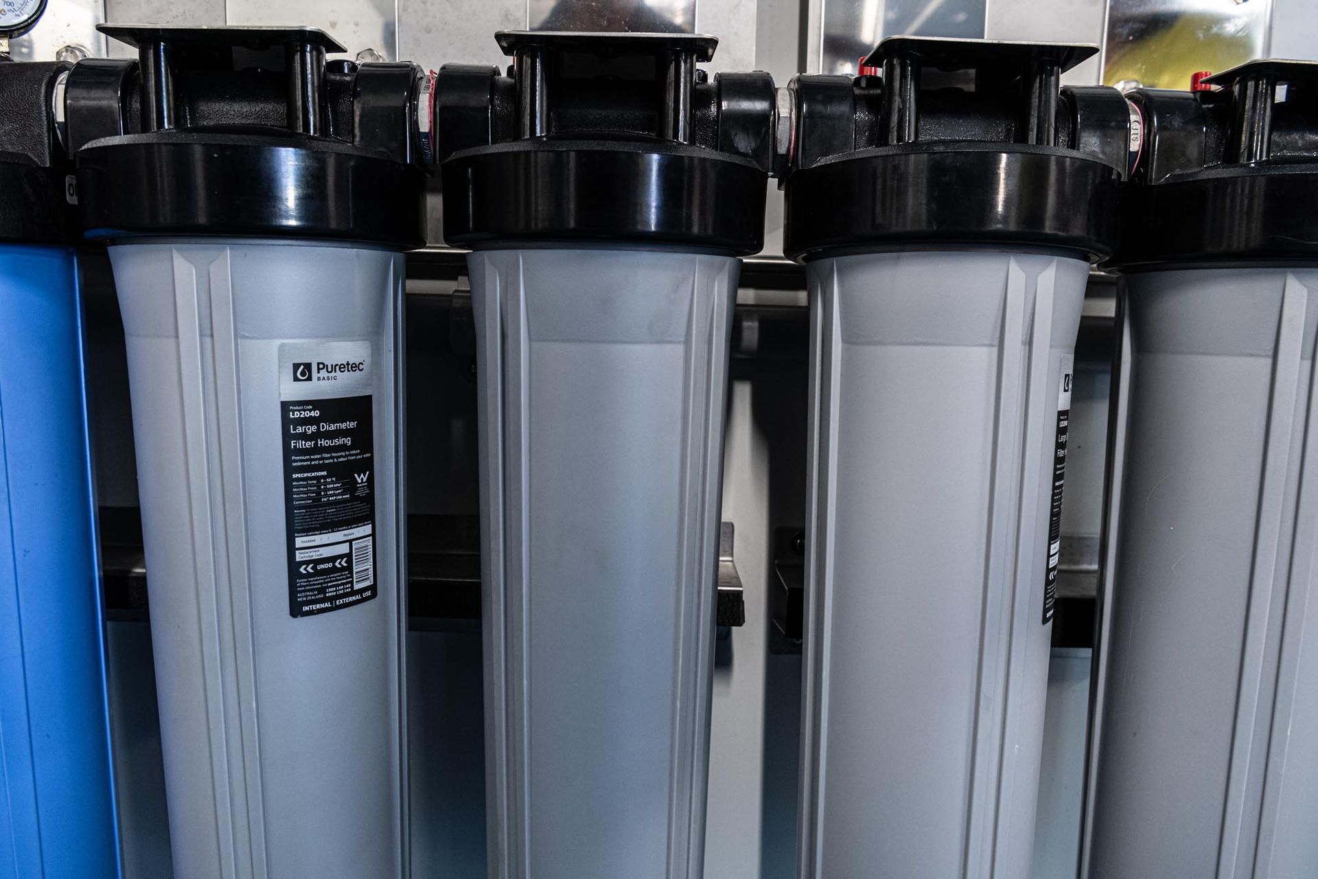 Rows of Tall Grey Water Filters With Black Tops in a Store Display — So Fresh Wide Bay in Thabeban, QLD
